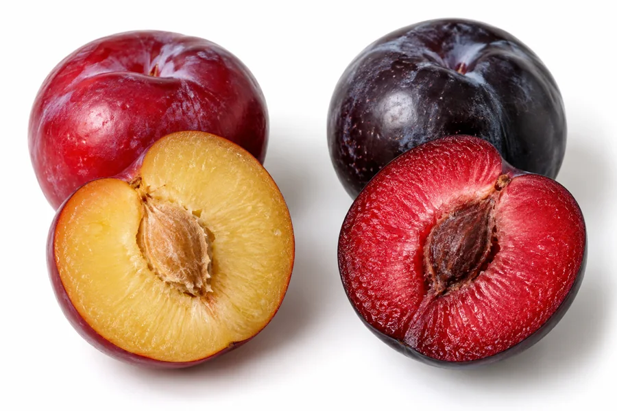 Red and near-black plums cut to reveal different flesh colors