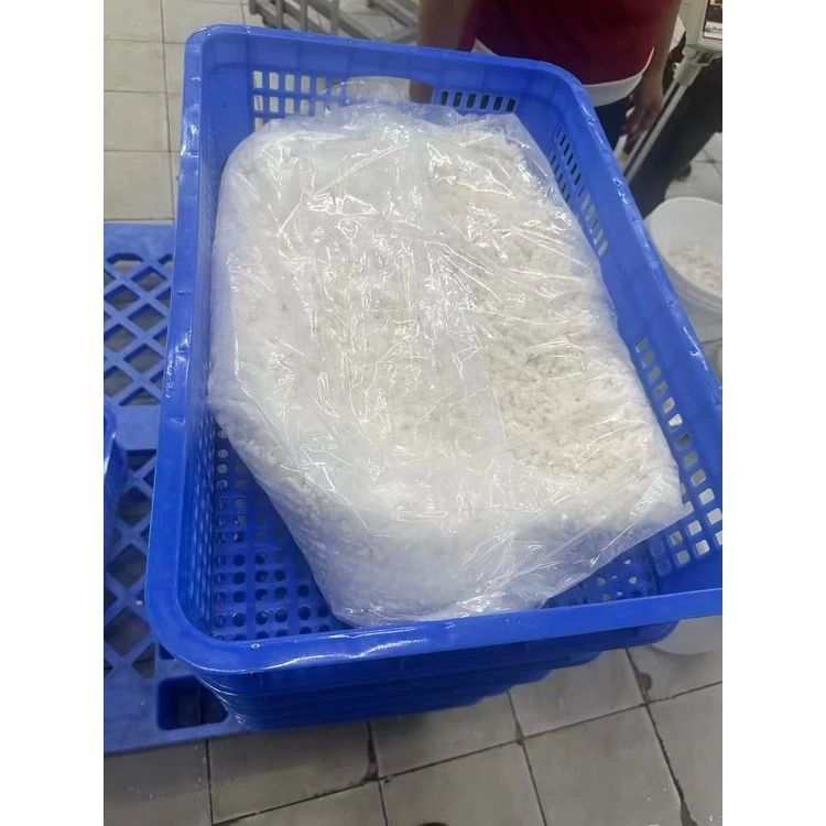 Packed white coconut meat in a blue crate